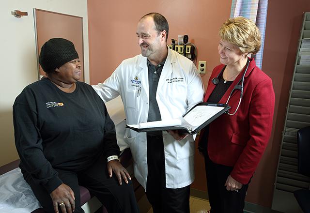 Hopkins doctors speak to patient in exam room